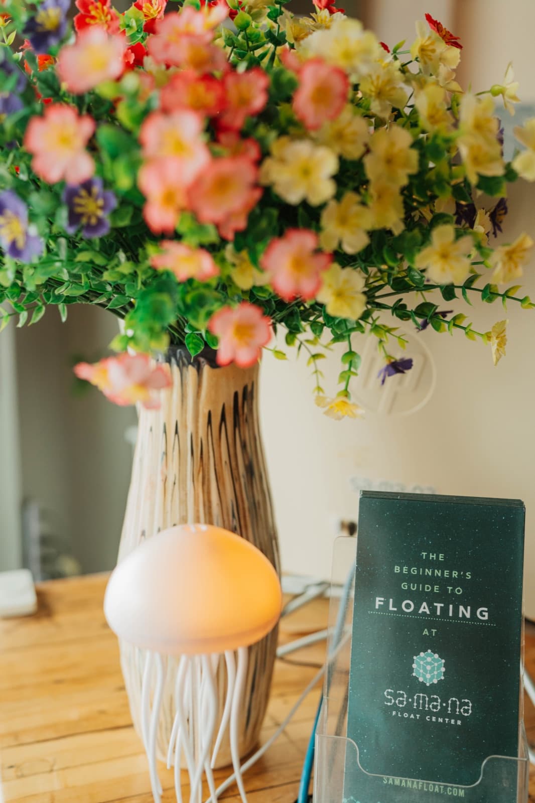 The welcome desk at Samana, with a jellyfish diffuser and a guide to floating